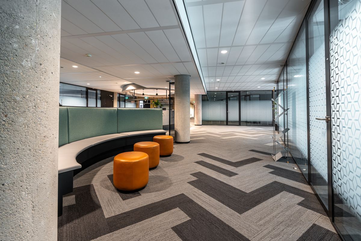 Clean modern open office with lounge seating and workstations