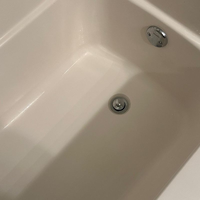 Bathtub buildup cleaned to a bright finish (after)